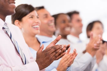 Happy business group applauding at the office