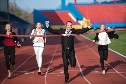 business people running together on racing track